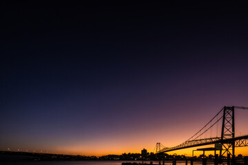 Colorful sunset behind the Hercílio Luz bridge in Florianópolis, copy space