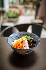 Cold japanese hiyashi chuka ramen on wooden table