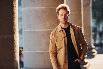 Elegant young man in formal classy clothes outdoors in the city