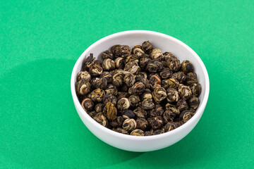 loose tea in a saucer and poured nearby on a contrasting background
