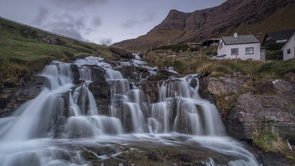 waterfall in the mountains in faore islands 