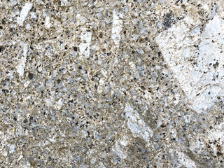 Close-up shot of a large rock with a white and gold dividing beside the sea that has been eroded by the sea until it is beautiful for artwork or graphic design. wallpaper, background, or backdrop.