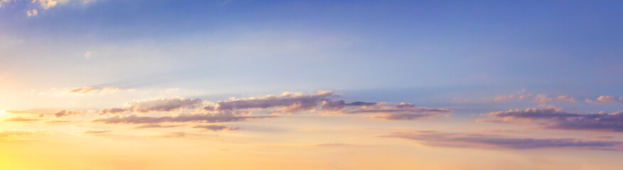 Panorama of picturesque sky with clouds during sunset
