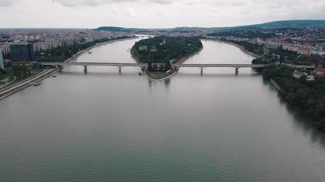 Aerial dolly slide view of Arpad bridge and Margaret Island in background surrounded by Danube River