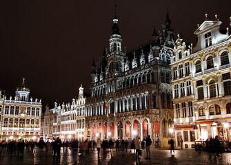 Fototapeta na wymiar Night shot of illuminated facades on the Grand Place or Square also used in English or Grote Markt that is the central square of Brussels.