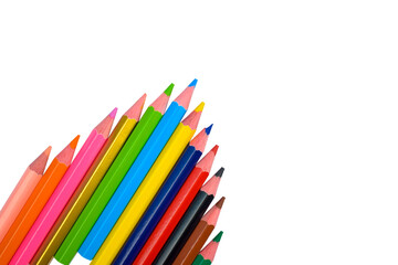 Fototapeta premium An arrow shaped made with some different colored wood pencil crayons on a white background