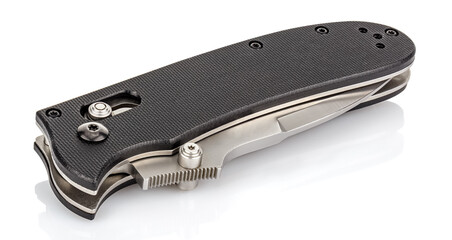 Closed folding pocket knife with textured black composite plastic cover plates on steel handle isolated on white background with reflection on glossy surface. Pocket knife close-up image