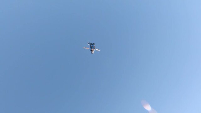Skydivers over snowy mountains in Norway