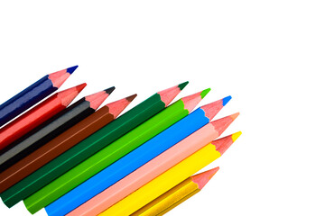 Fototapeta premium Many different colored wood pencil crayons scattered on a white background