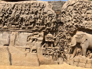 Fototapeta premium Bas relief sculptures on the wall of the rock cut cave temples in Mahabalipuram, Tamil nadu.