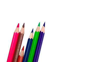 Fototapeta premium Six different colored wood pencil crayons scattered on a white background