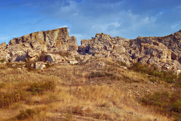 Fototapeta na wymiar The rocks in the azov steppe at the dawn under the blue sky