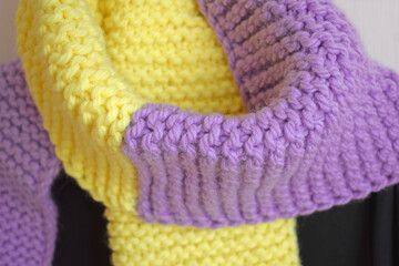 A warm lilac-yellow scarf, knitted with thick yarn.Handmade work.