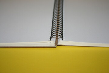 a paper new notebook on a yellow background