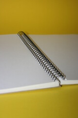 a paper new notebook on a yellow background