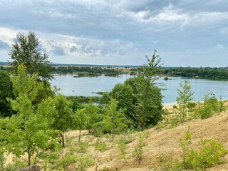 Old abandoned sand pit on a summer cloudy day
