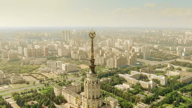 Aerial view of the cityscape as seen behing the spire and star of the historic Moscow State University building, Russia
