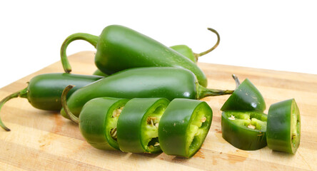 A pile of finely chopped chilli peppers in wooden board on a white background