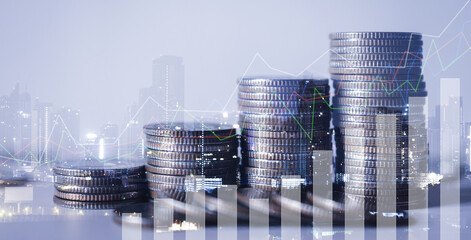 double exposure of city with row of coin stack with growth chart and graph progress report for...