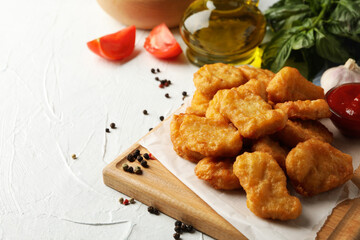Composition with chicken nuggets, ketchup and potato on white background