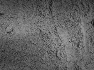 Gray sand texture, concrete-like color, rough surface background.
