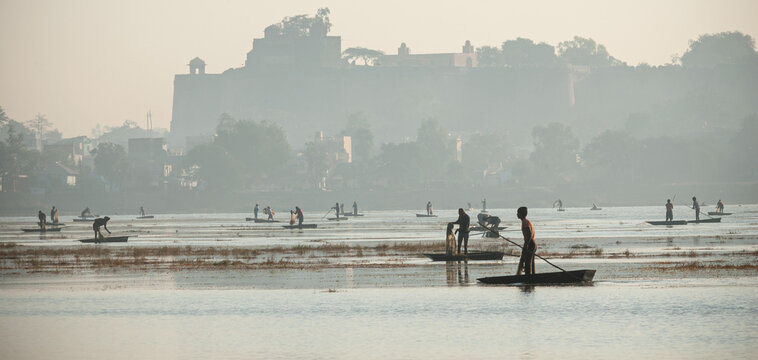 Fishermen catching fish at lake in Dhar city of madhya pradesh state. India.