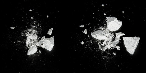 Splash, destroy, explosion by white pieces plaster, stone, chalk on black background