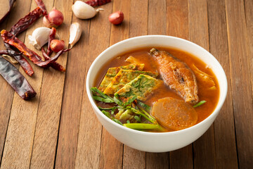 Sour soup with fried fish and mixed Vegetable,Thai red soup with water mimosa ,Chinese Cabbage ,Radish and Fried Egg with Climbing Wattle