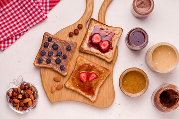 Peanut butter and jelly sandwich on a wooden board. white background