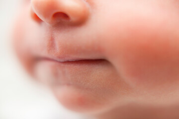 Newborn baby lips. Close up. Face of baby boy. Blurred. 