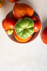 fresh seasonal tomatoes on a plate top view