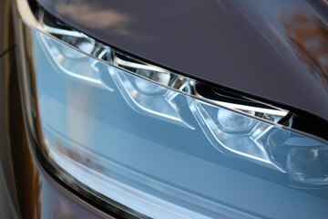 Fototapeta na wymiar Detail of a new vehicle headlight 