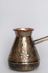 Cezve. copper turk for coffee on a light background on the stove. close-up