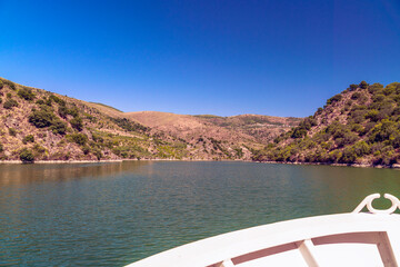 bow of the boat sailing on the Douro River in the Arribes del Duero between the rocky mountains in...