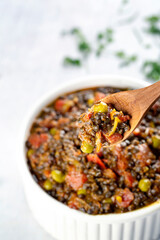 Black lentil curry detail with wooden spoon