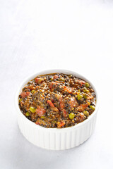 Black lentil curry on white bowl isolated on white background