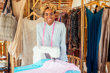 brazilian designer female with cute blonde afro curls hair making handmade clothes in her tropical eco house in Bali