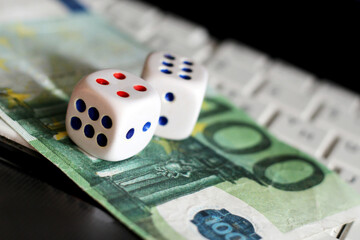 One bill of one hundred of euros and the dice so close