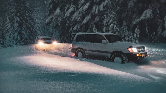 Offroad SUVs Driving In The Snow At Night In Central Oregon