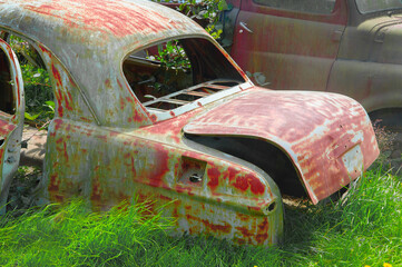 Abandoned rusted vintage American car in field