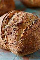 Homemade Freshly Baked Country Bread  made from wheat and whole grain flour on a dark background. French Freshly baked bread. 