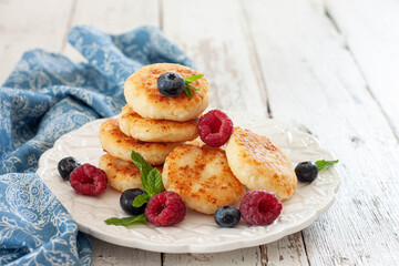 Cottage cheese pancakes with raspberries and blueberries.Tasty breakfast