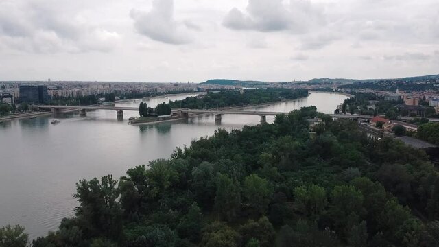 Aerial forward flyover Budapest city with beautiful panoramic view on Danube river with Arpad bridge and Margaret Island