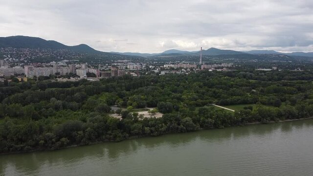 Aerial shot showing Construction of Obuda district with housing area and mountains in background