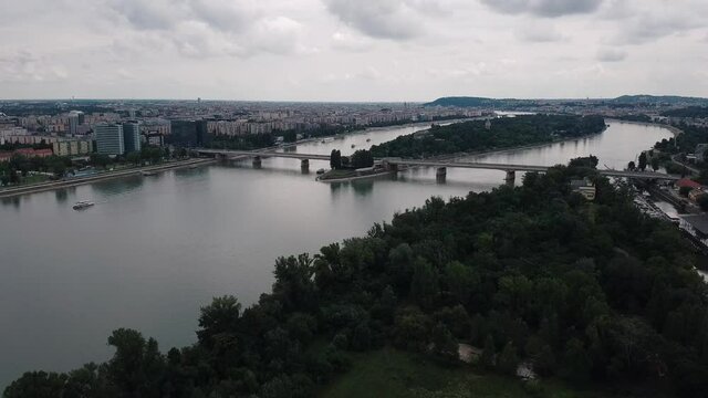 Dramatic Aerial flight showing Budapest city and Margaret Island during dusty cloudy day
