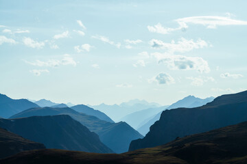 Obraz premium Awesome aerial view to great mountains in distance behind deep gorge. Scenic mountain landscape with giant rockies and deep abyss. Wonderful highland scenery with huge cliff. Big rocks and precipice.