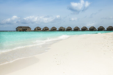 Villas on white sands and vibrant seas of Maldives