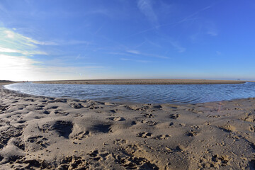 The beach and the sea coast on a sunny day in the fisheye lens.