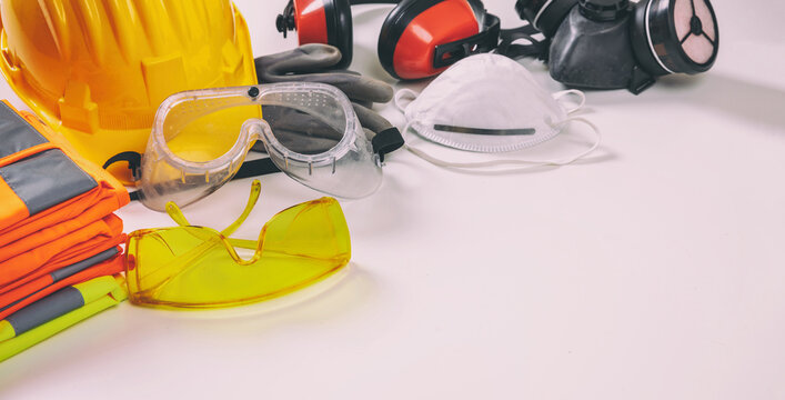 Work safety protection equipment background. Industrial protective gear on white