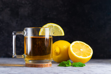 Green herbal tea with mint, lemon and honey in a low key